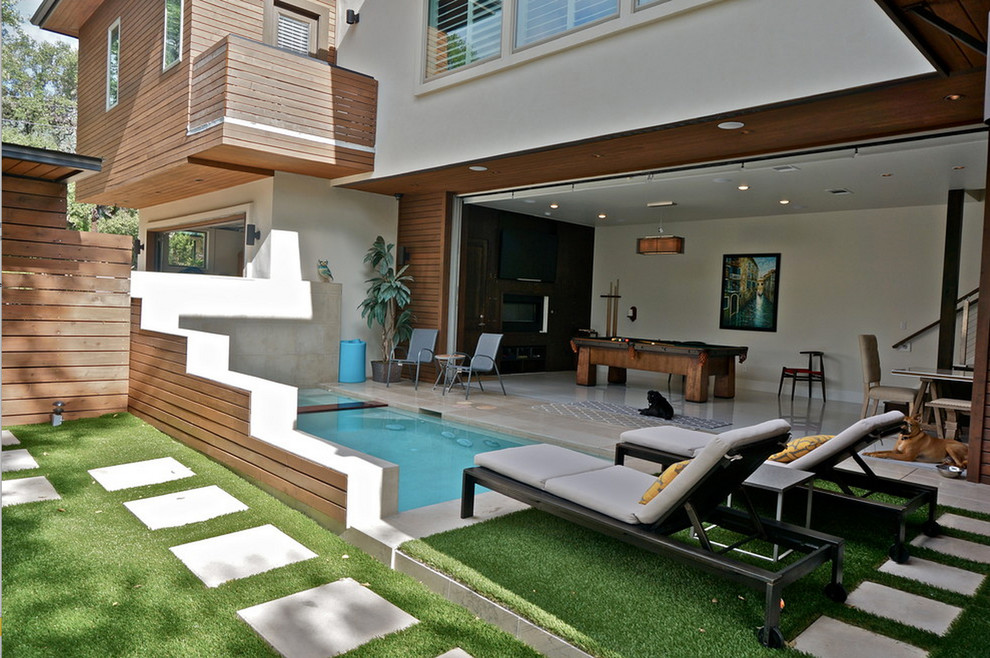 This is an example of a medium sized modern courtyard partial sun garden for summer in Austin with an outdoor sport court and concrete paving.