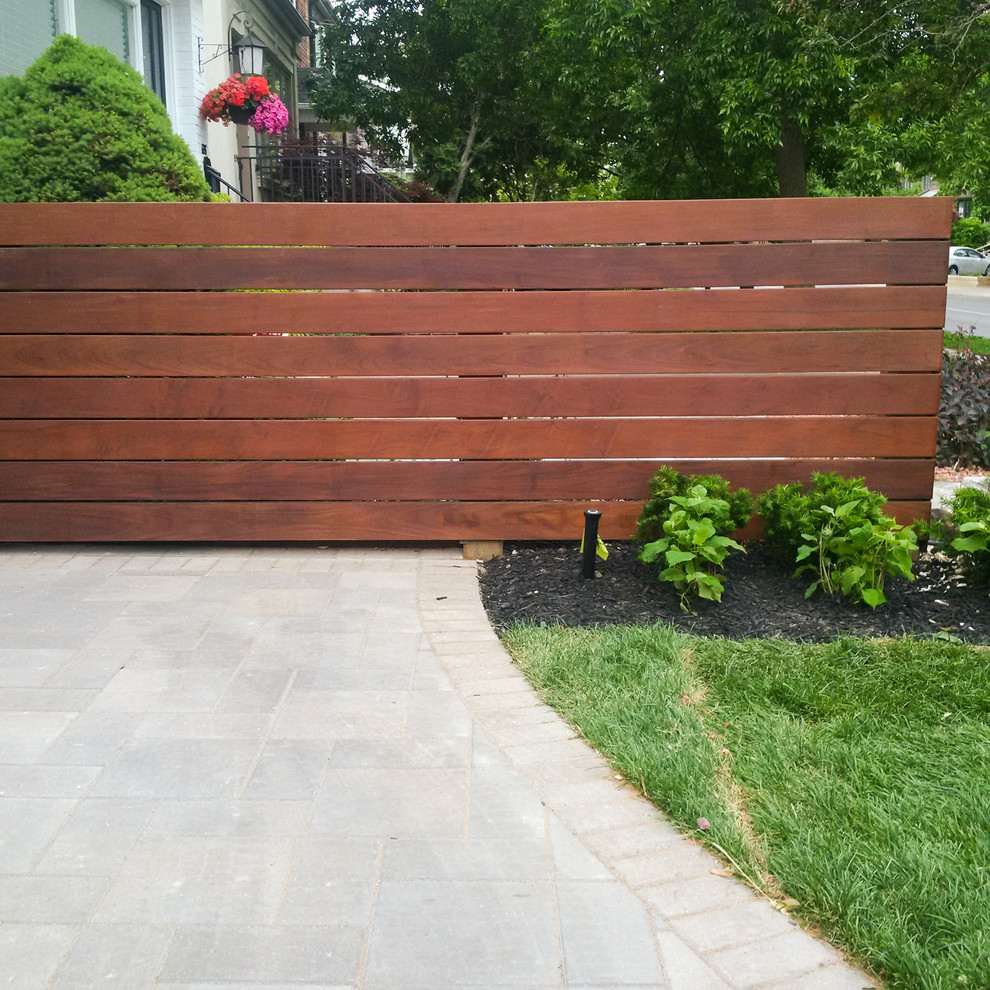 This is an example of a small modern full sun side yard concrete paver landscaping in Toronto for spring.