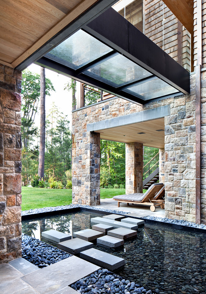 Inspiration for a contemporary garden in New York with a water feature.