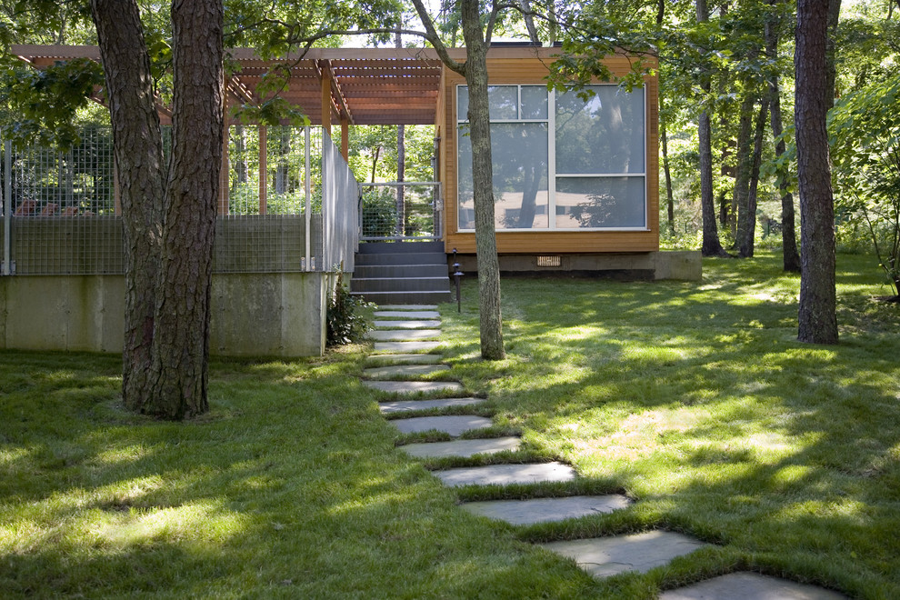 This is an example of a modern back garden steps in New York with natural stone paving.