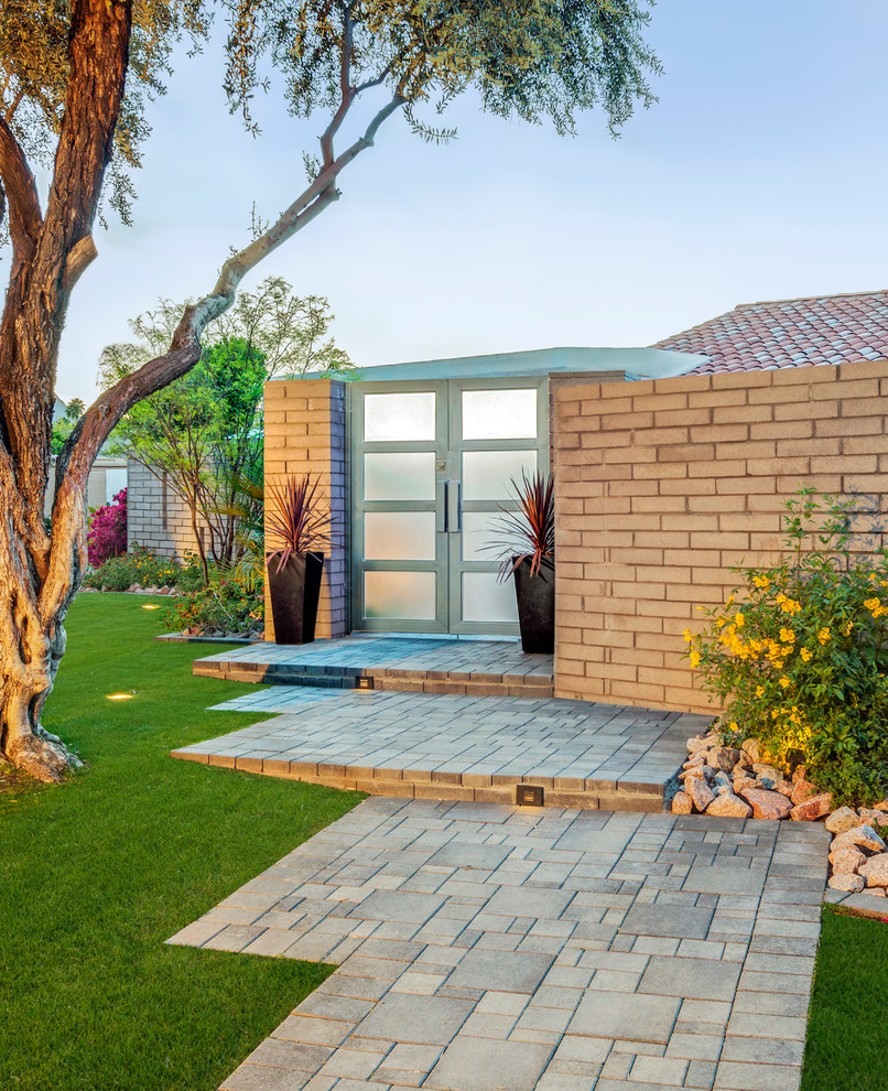 This is an example of a mid-sized modern partial sun front yard concrete paver garden path in Phoenix.