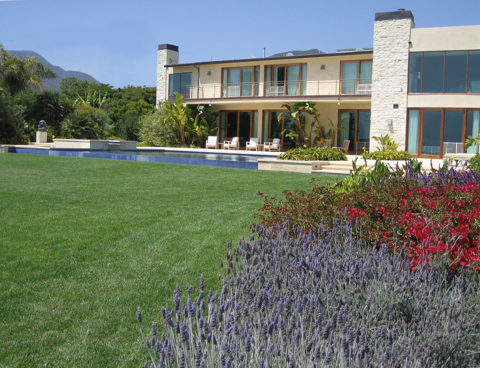 Inspiration for a large mediterranean back formal full sun garden for autumn in Orange County with concrete paving.