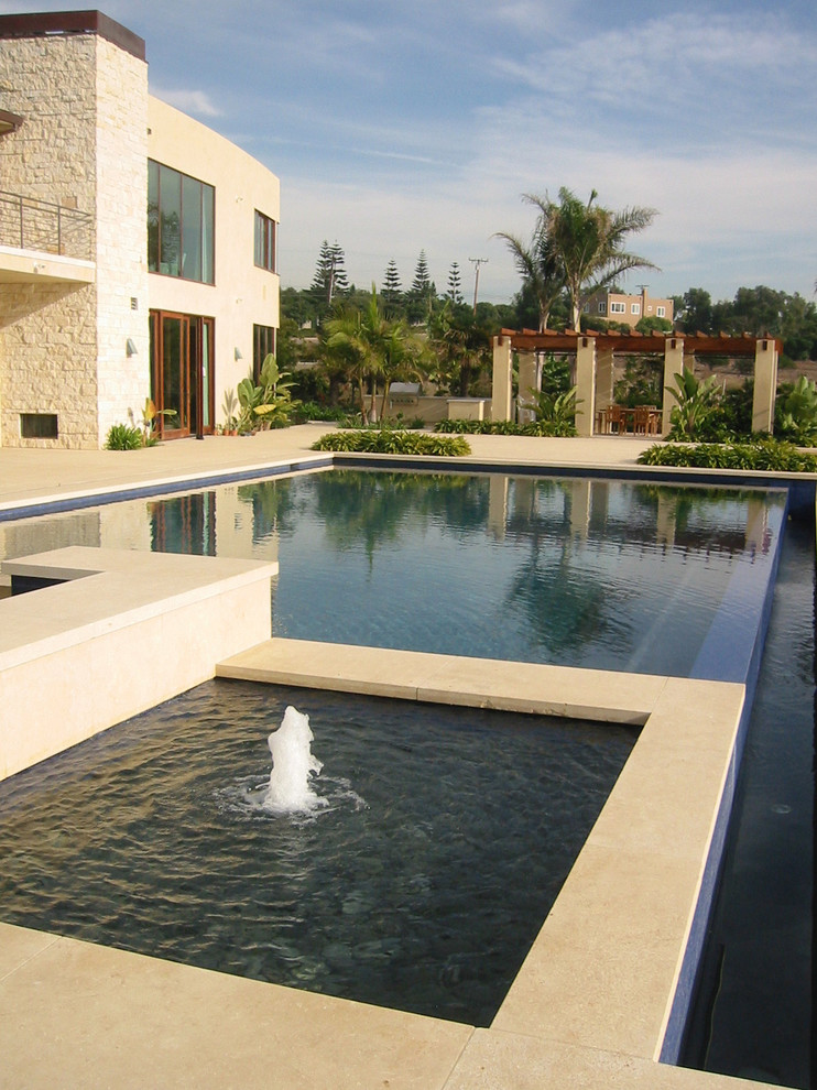 Design ideas for a large mediterranean full sun backyard concrete paver landscaping in Orange County for fall.