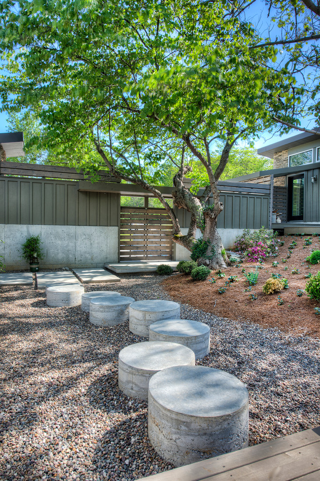 Contemporary garden in Other with gravel.