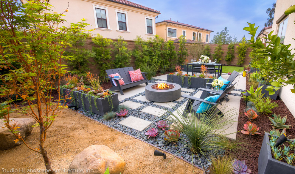Photo of a small modern drought-tolerant and partial sun backyard concrete paver landscaping in Orange County.