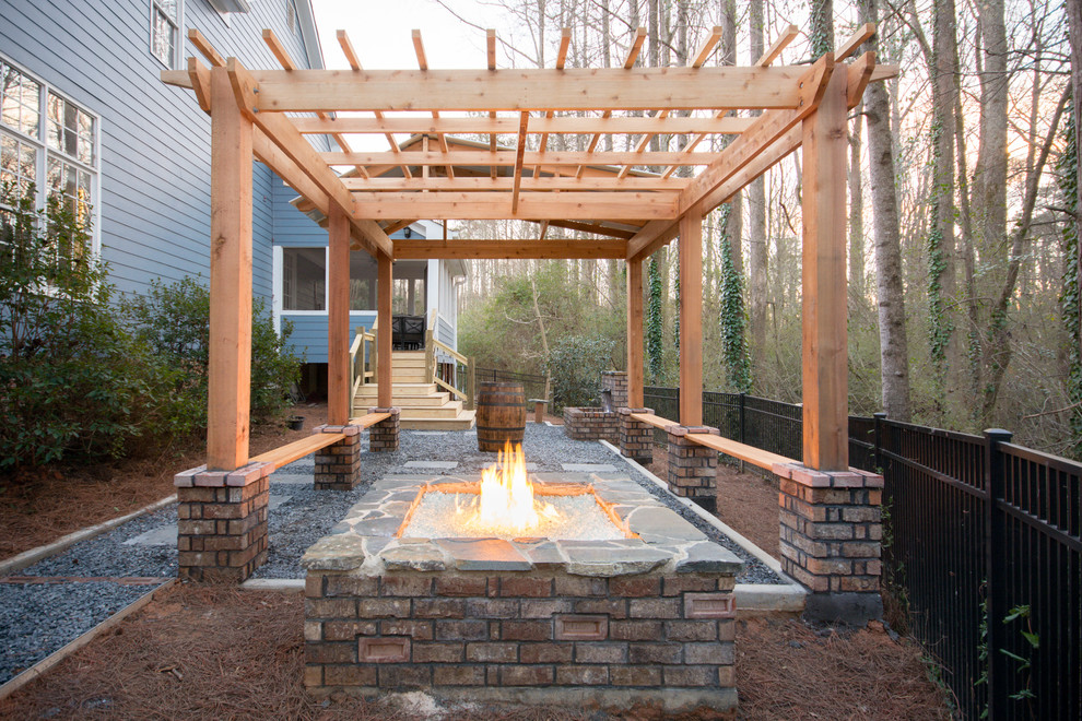 Photo of a small modern back partial sun garden for spring in Atlanta with a fire feature and gravel.