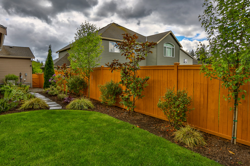 Design ideas for a large traditional partial sun backyard landscaping in Seattle.