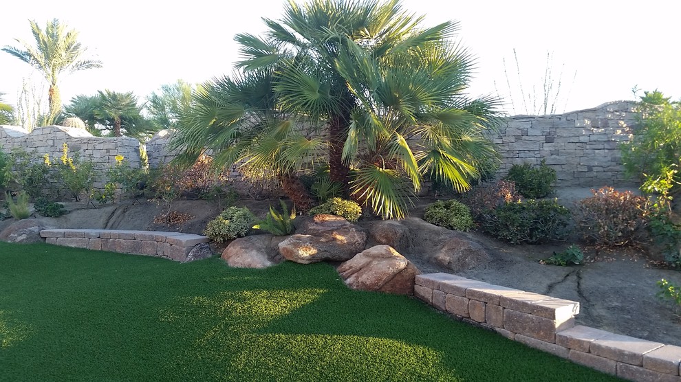 Design ideas for a huge southwestern drought-tolerant and partial sun backyard retaining wall landscape in Other.