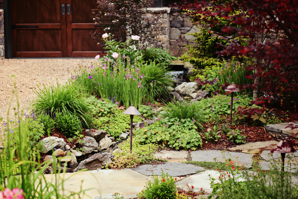 Design ideas for a mid-sized traditional full sun front yard stone water fountain landscape in Charlotte for spring.