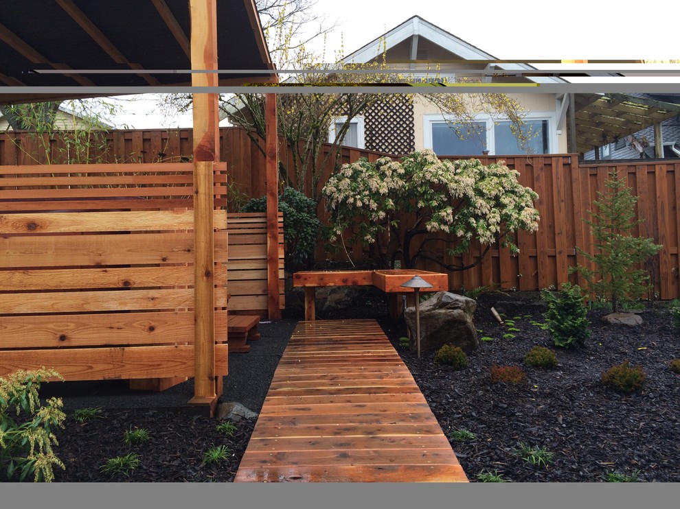 Inspiration for an asian backyard landscaping in Portland with decking.