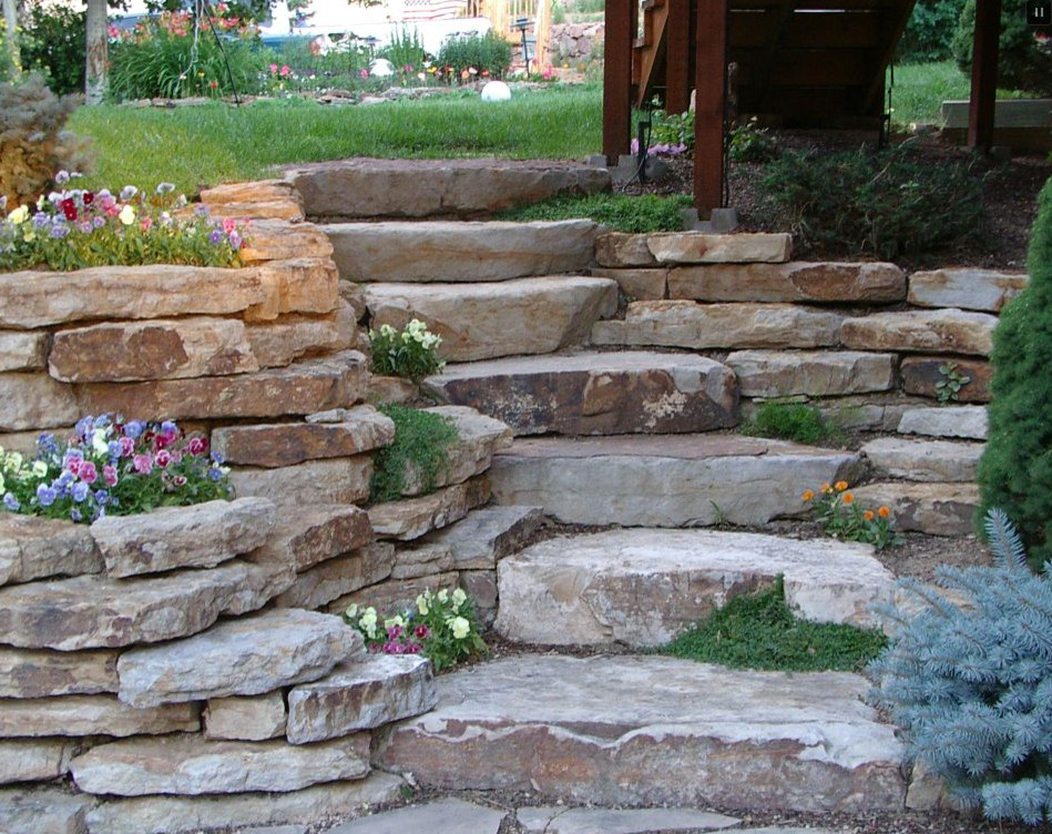 Design ideas for a large traditional shade backyard stone retaining wall landscape in Bridgeport.