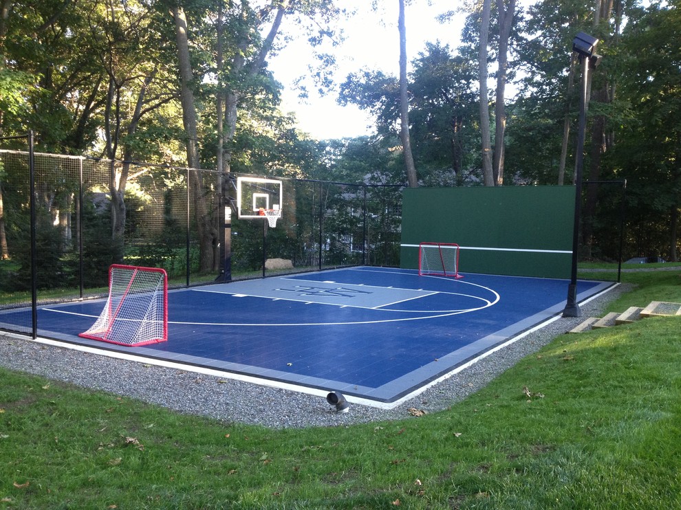 This is an example of a small traditional partial sun backyard concrete paver outdoor sport court in Boston.