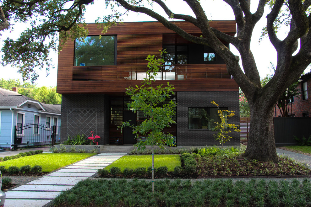 Photo of a medium sized modern front fully shaded garden in Houston with concrete paving.
