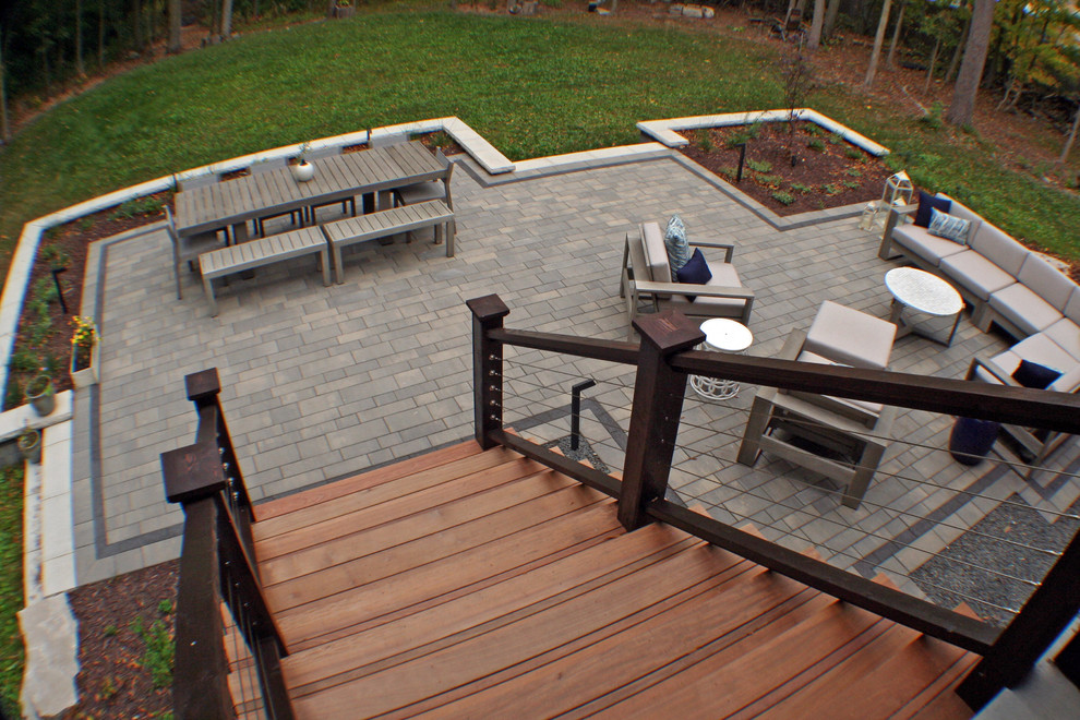 Photo of a medium sized contemporary back partial sun garden for autumn in Milwaukee with natural stone paving.