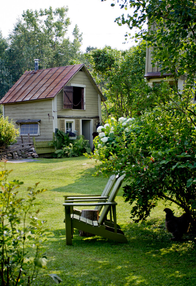 Design ideas for a farmhouse partial sun backyard landscaping in New York.
