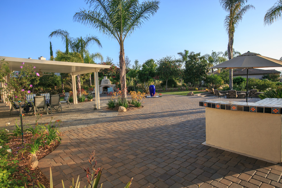Inspiration for a large traditional back garden in San Diego with a fire feature and concrete paving.