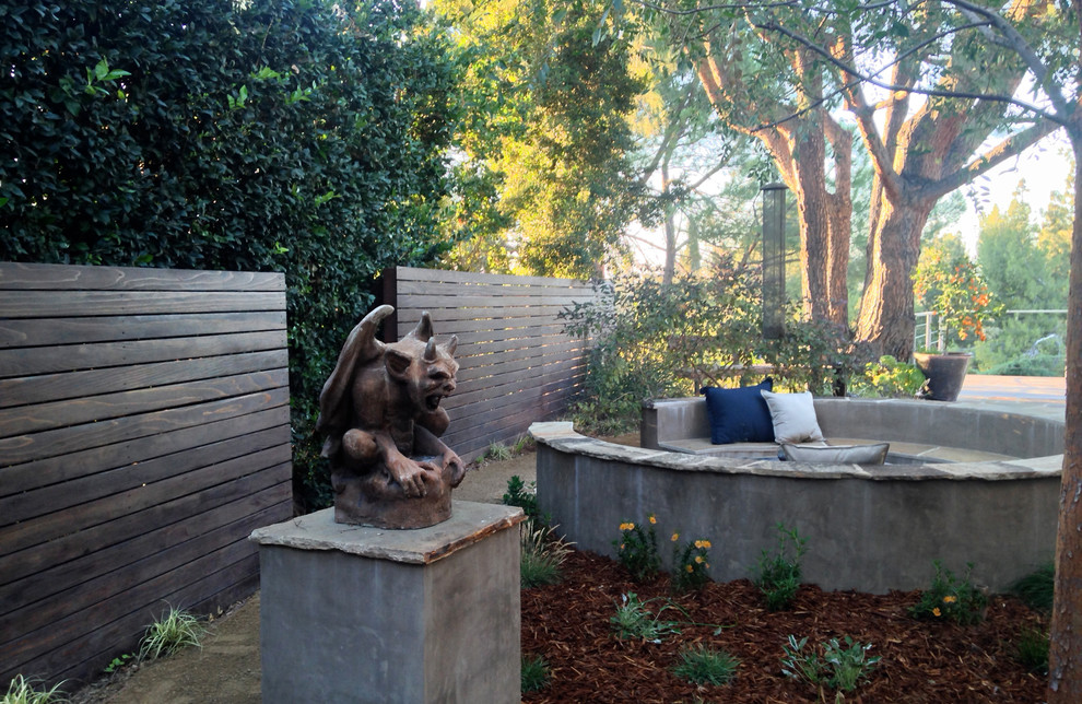 Photo of a medium sized eclectic side partial sun garden in Los Angeles with a garden path and natural stone paving.