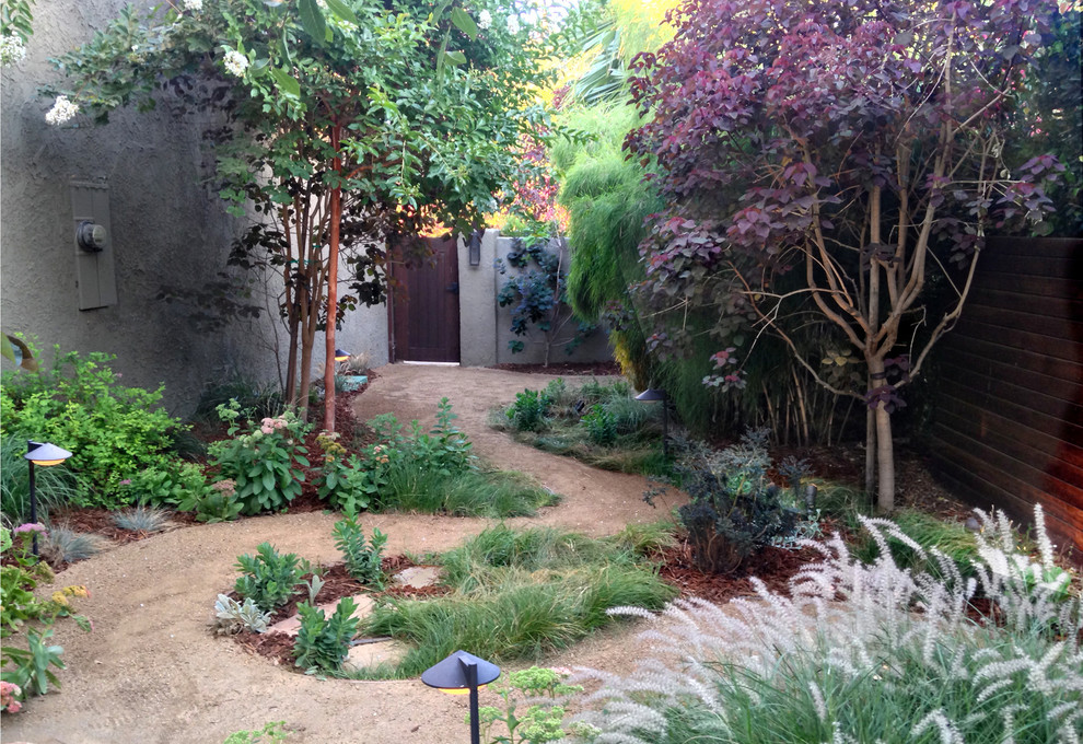 This is an example of a mid-sized eclectic partial sun side yard stone garden path in Los Angeles.