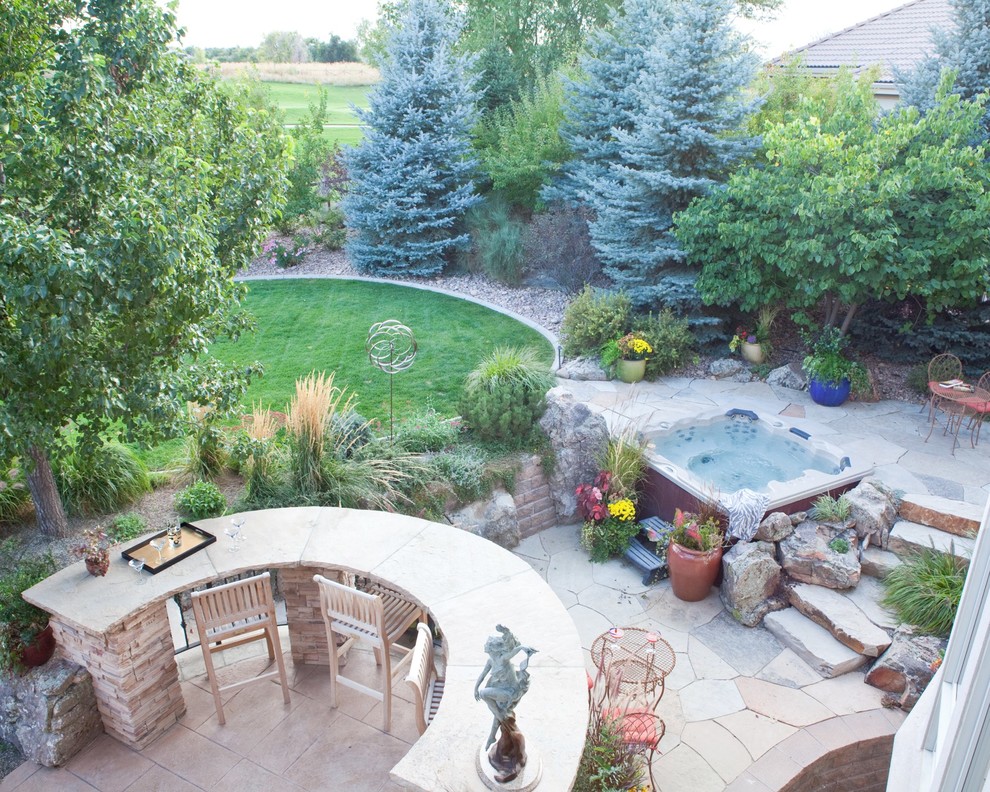Design ideas for a large classic back full sun garden in Denver with a water feature and natural stone paving.
