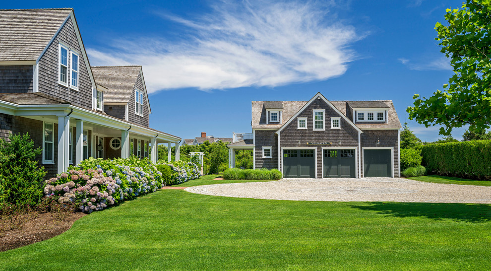 Photo of an expansive coastal front driveway full sun garden in Boston with gravel.