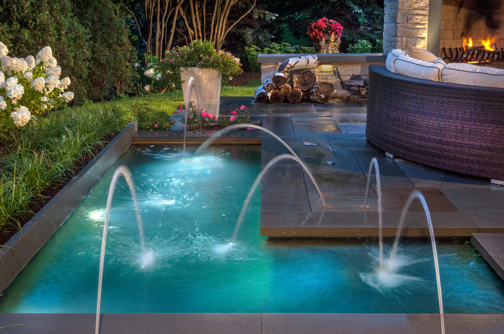 Пример оригинального дизайна: бассейн среднего размера на заднем дворе в стиле модернизм с фонтаном и покрытием из каменной брусчатки