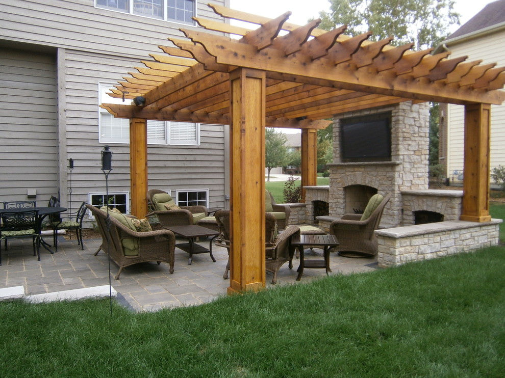 Patio - large traditional backyard concrete paver patio idea in Chicago with a fire pit and a pergola