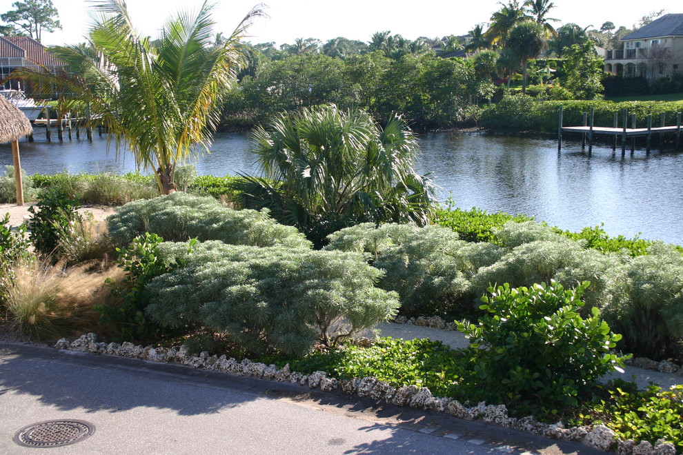 Esempio di un giardino xeriscape stile marino esposto in pieno sole di medie dimensioni in estate con un ingresso o sentiero, un pendio, una collina o una riva e ghiaia