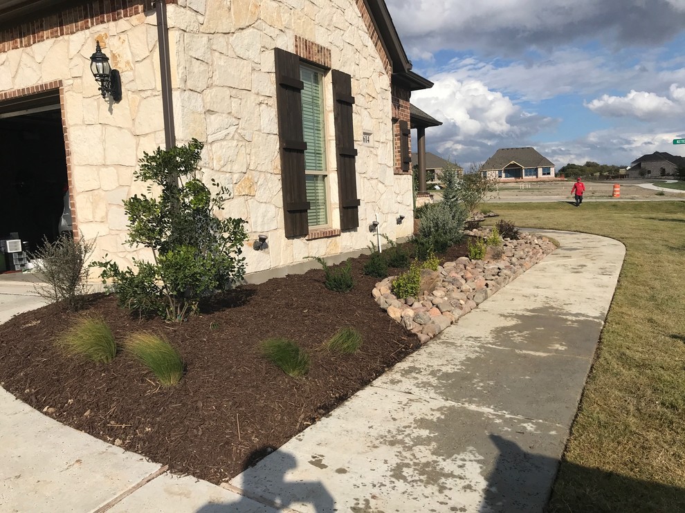 This is an example of a medium sized rustic front garden in Dallas.