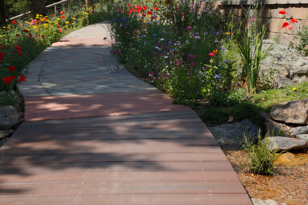 Inspiration for a large rustic back formal partial sun garden in Denver with a garden path and natural stone paving.