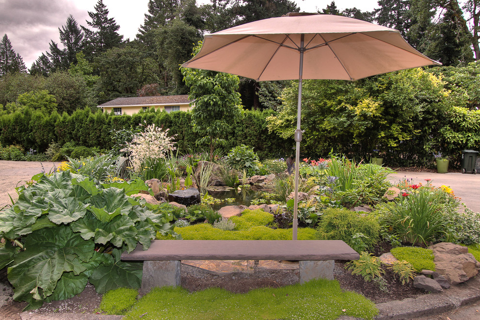 Rustic garden seating in Portland with a water feature.