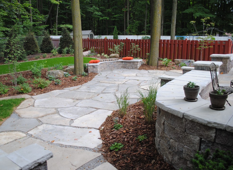Photo of a contemporary back garden in Toronto with natural stone paving.