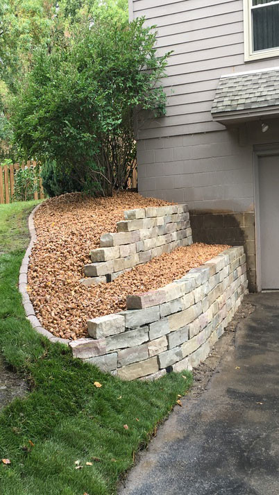 Photo of a small front yard retaining wall landscape in Minneapolis.
