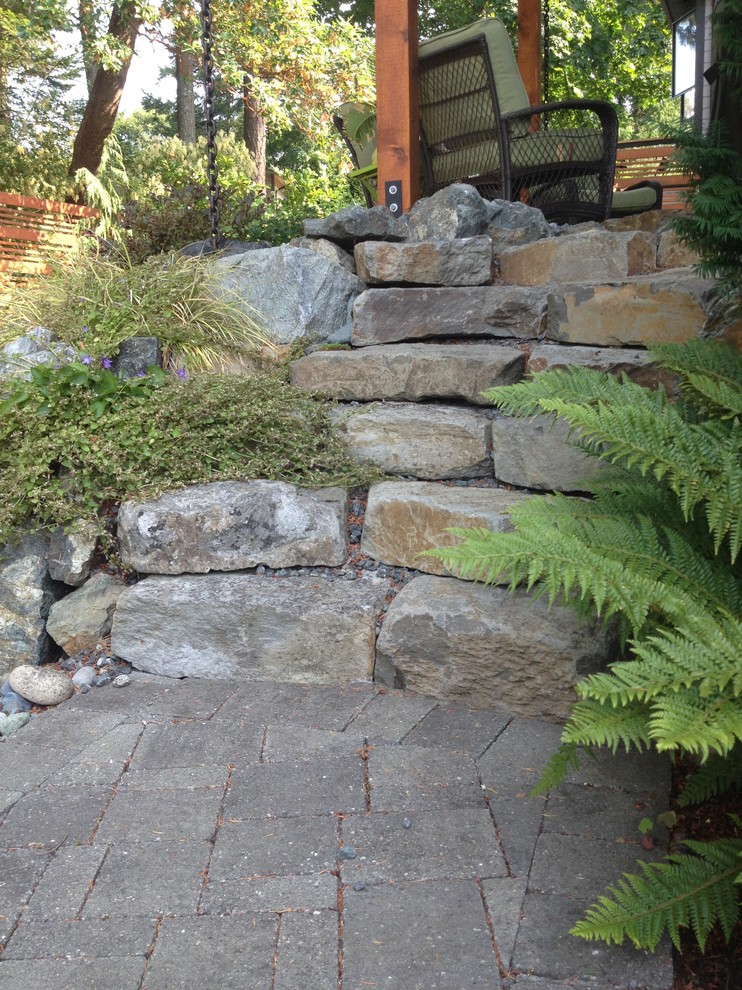 Photo of a mid-sized contemporary shade backyard stone garden path in Vancouver for summer.