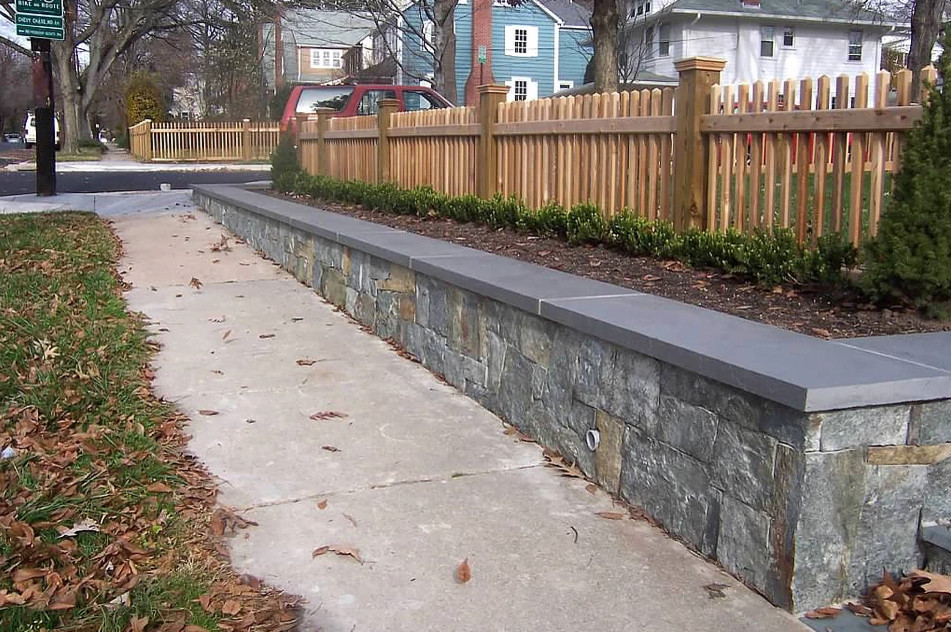 Design ideas for a mid-sized full sun front yard stone retaining wall landscape in Other.