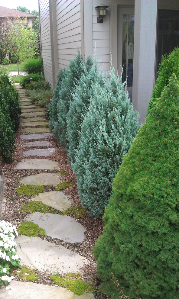 This is an example of a traditional side garden in New York with natural stone paving.