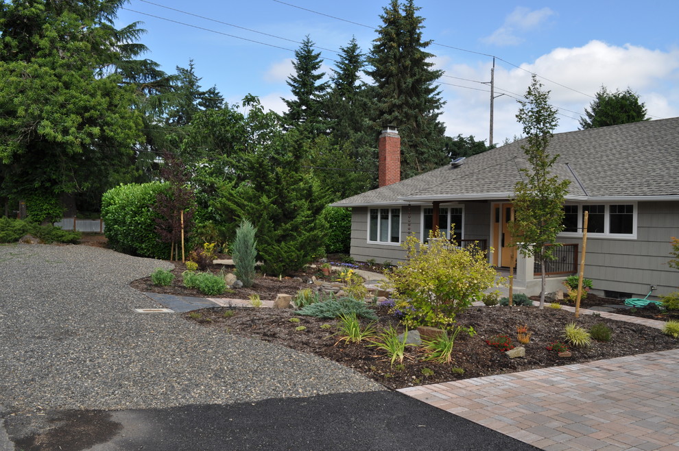 This is an example of a mid-sized contemporary front yard concrete paver driveway in Portland.