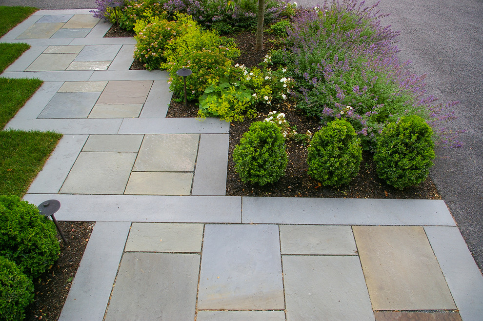 This is an example of a small traditional front full sun garden in Boston with natural stone paving.