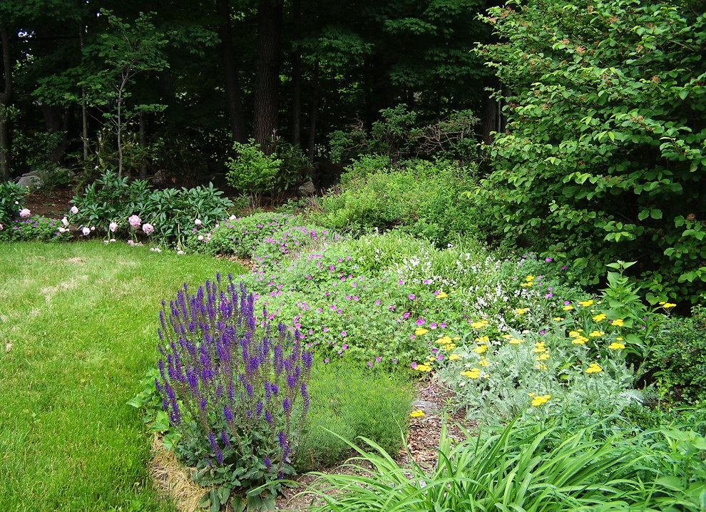 Photo of a medium sized eclectic front full sun garden for summer in Boston with natural stone paving.