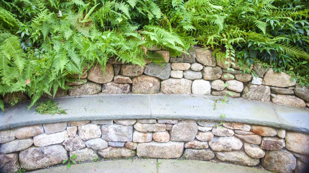 Foto di un giardino eclettico esposto in pieno sole di medie dimensioni in estate con un muro di contenimento, un pendio, una collina o una riva e pavimentazioni in pietra naturale