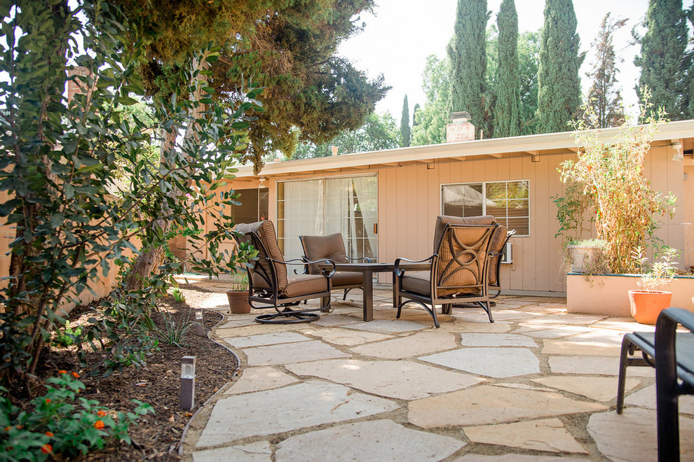 Design ideas for a medium sized contemporary back patio in Los Angeles with natural stone paving.