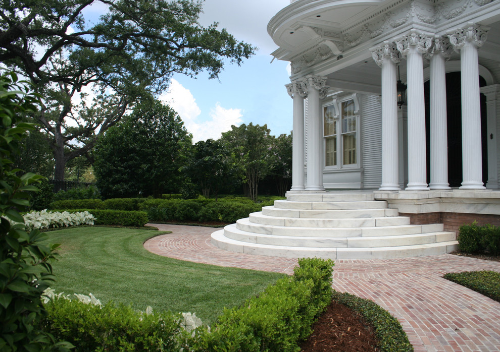 Design ideas for a classic front partial sun garden steps in New Orleans with brick paving.