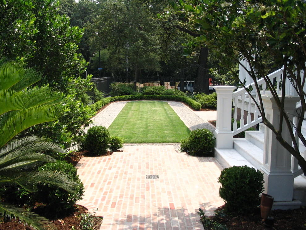 На фото: участок и сад в классическом стиле с мощением клинкерной брусчаткой и газонным бордюром с