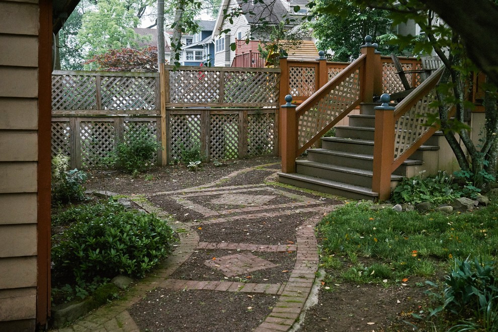Immagine di un giardino formale chic esposto a mezz'ombra di medie dimensioni e dietro casa in primavera con un ingresso o sentiero e pavimentazioni in mattoni