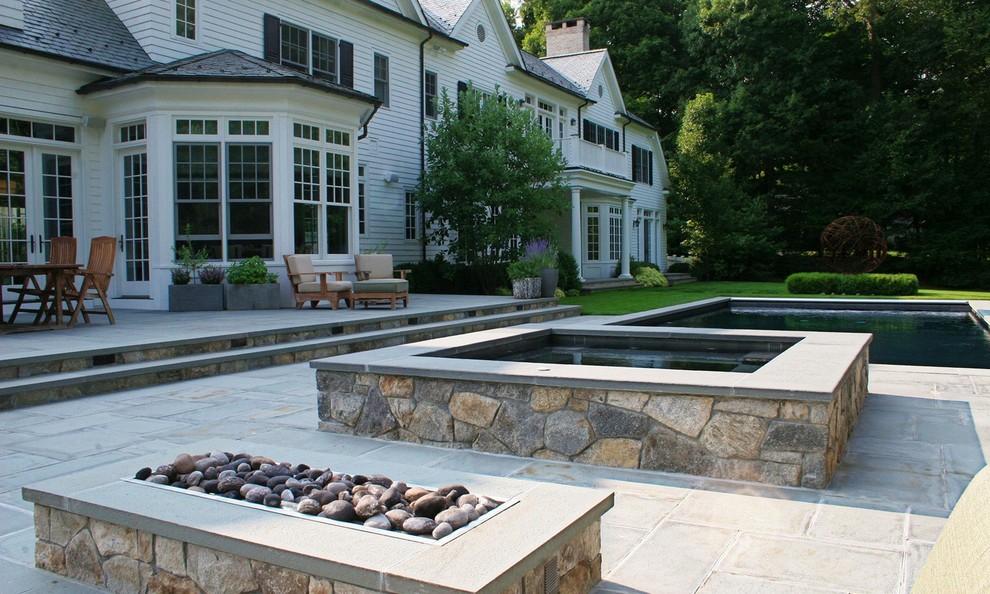 Inspiration for a traditional full sun backyard stone landscaping in New York.