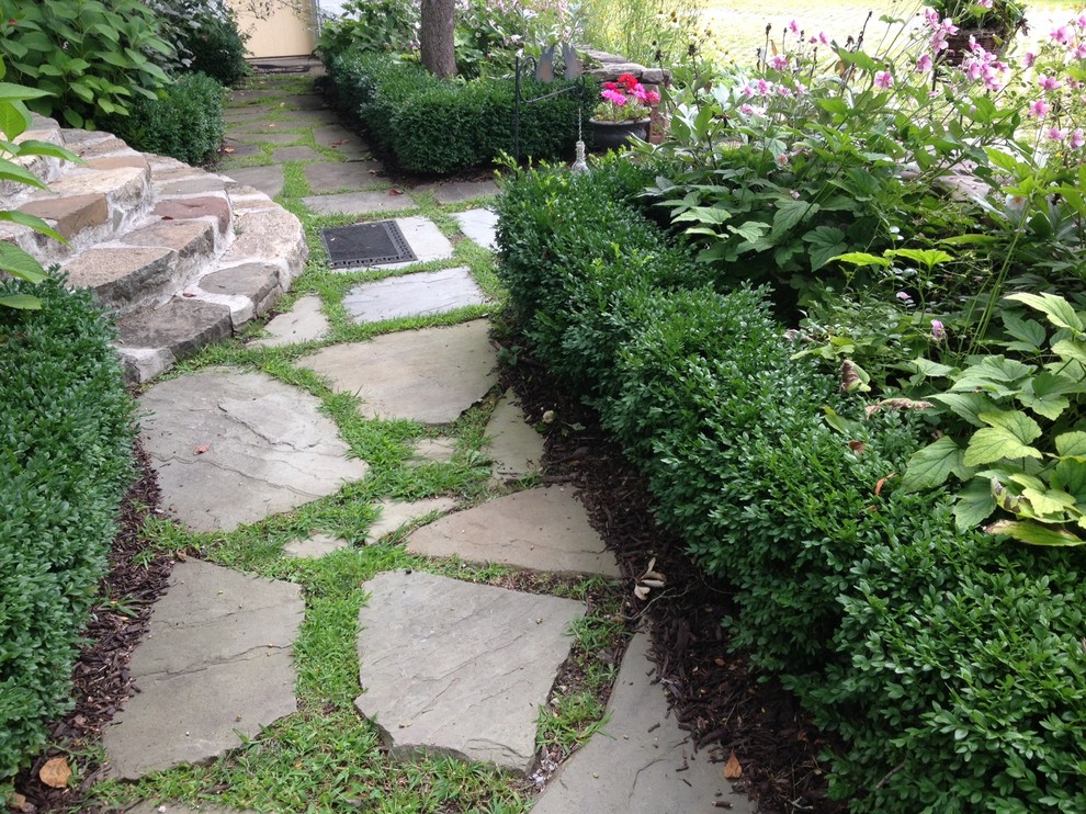 This is an example of a large rustic partial sun courtyard stone garden path in New York for summer.