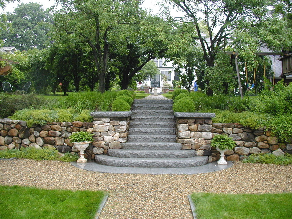 Design ideas for a traditional sloped garden steps in Boston with gravel.