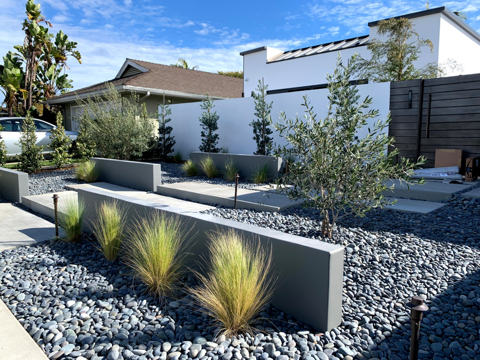 This is an example of a modern front yard river rock landscaping in Orange County.