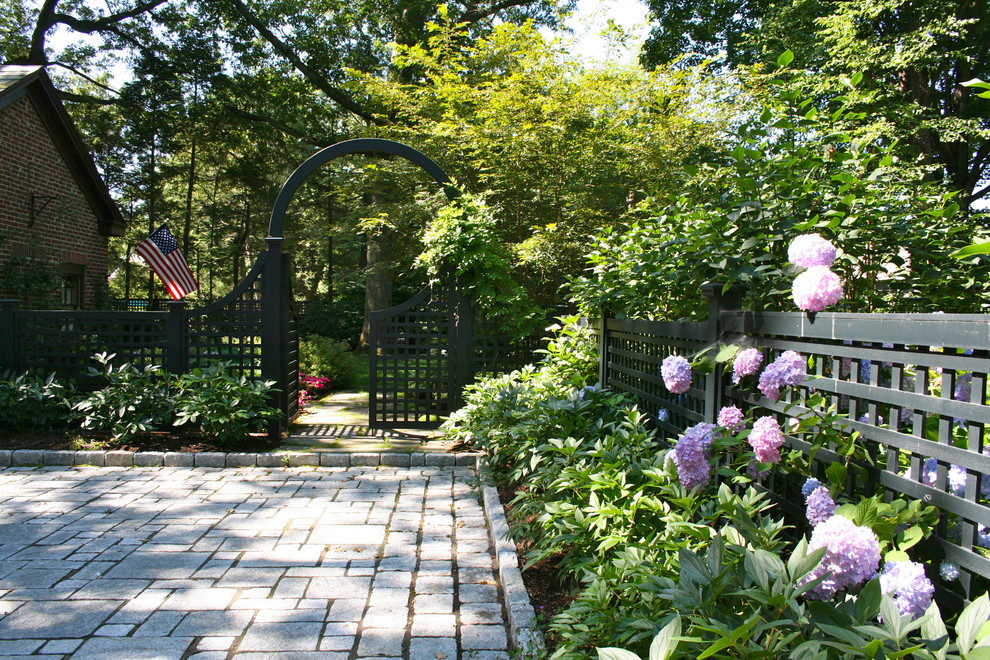 Design ideas for a large traditional partial sun front yard stone landscaping in Boston.
