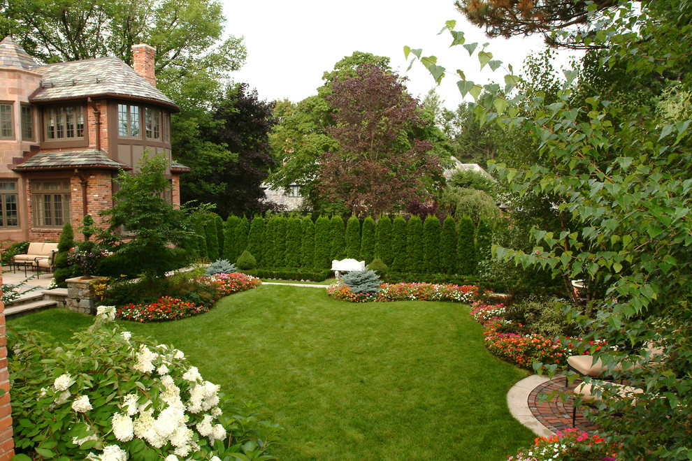 Photo of a large traditional backyard concrete paver landscaping in Boston.