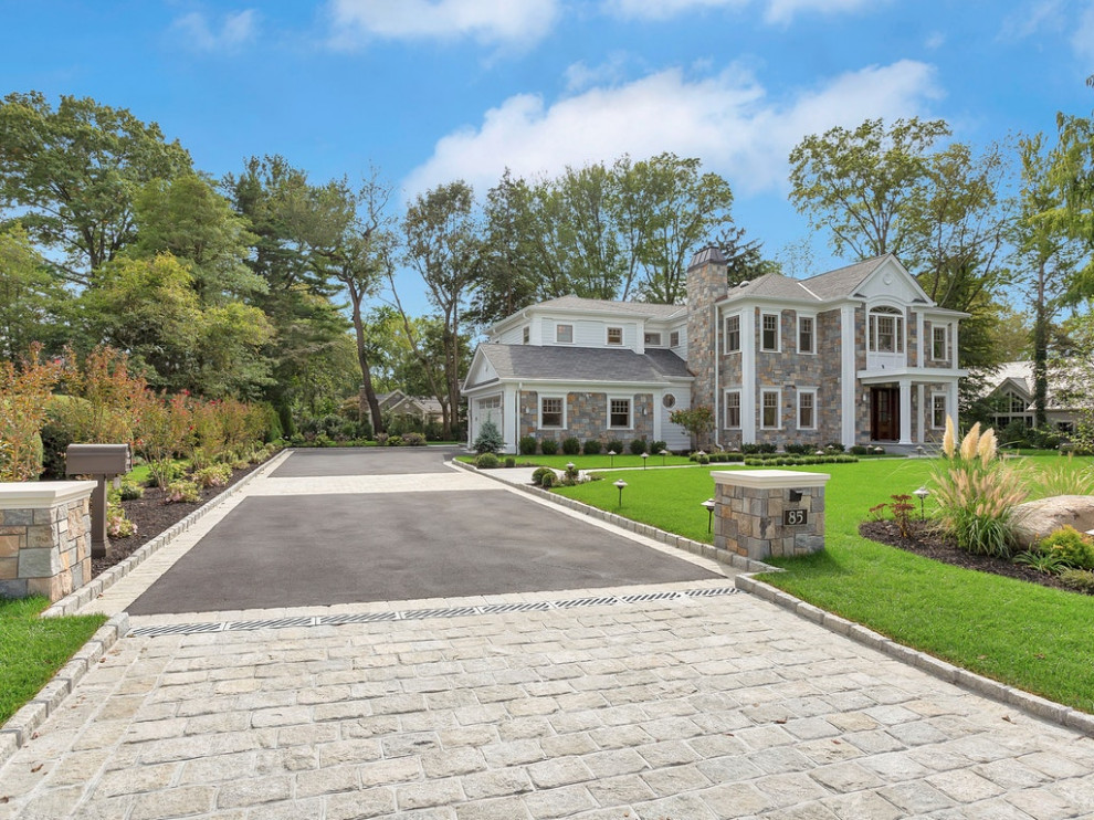 This is an example of a huge contemporary full sun stone landscaping in New York.